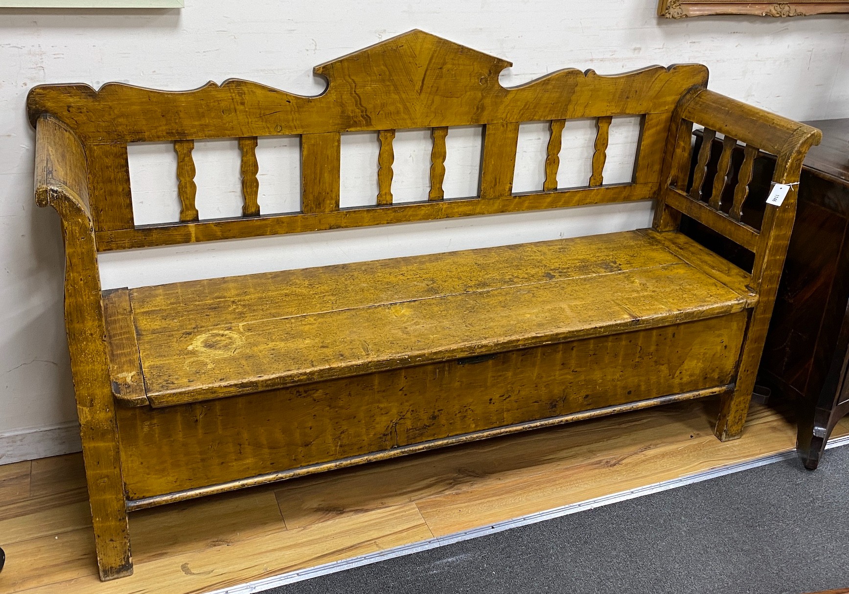 A 19th century Continental pine box seat settle with painted grain, width 190cm, depth 51cm, height 114cm